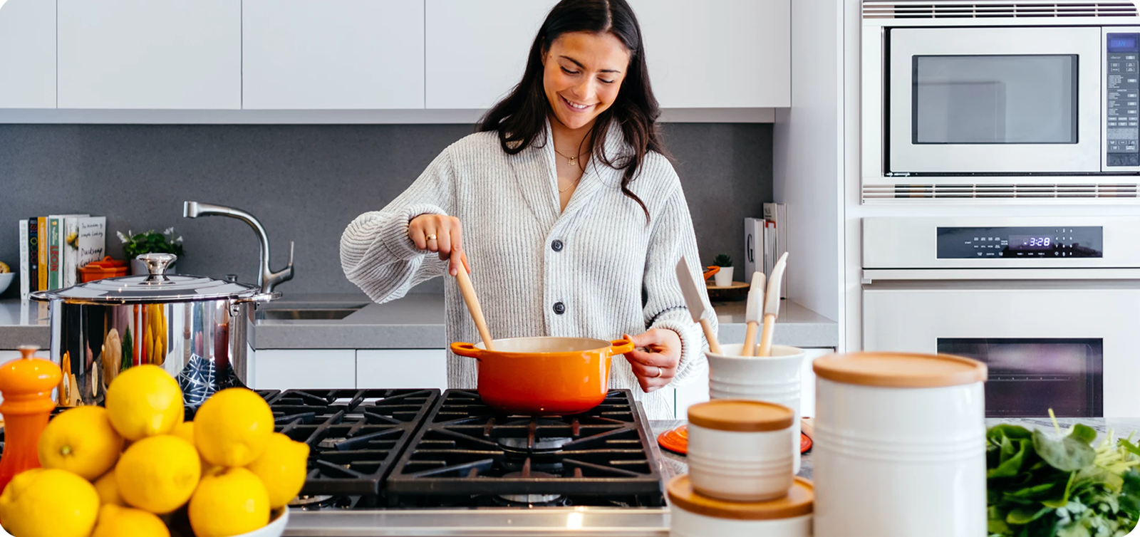 Home cook stirring a pot on a gas range